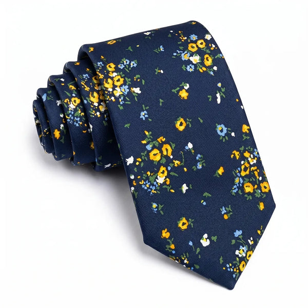 Close-up of a navy ditsy floral tie featuring yellow, light blue, and white miniature flowers on a smooth polyester fabric.