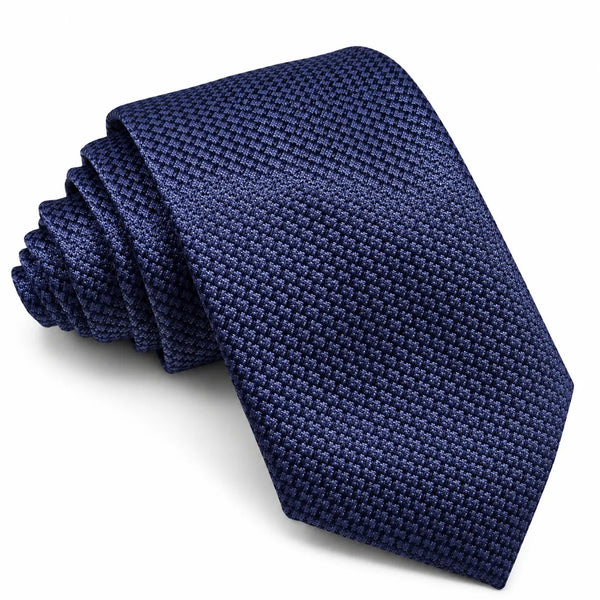 A dark navy blue textured necktie with a woven pattern, shown folded on a clean white background.
