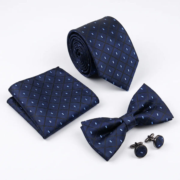 Flat lay of a Sailor Australia navy diamond dotted 4-piece tie set including a tie, pocket square, bow tie, and cufflinks.