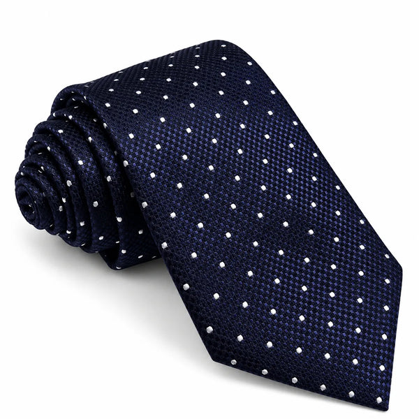 A rolled navy blue necktie with a fine textured pattern and small white polka dots, displayed on a clean white background.