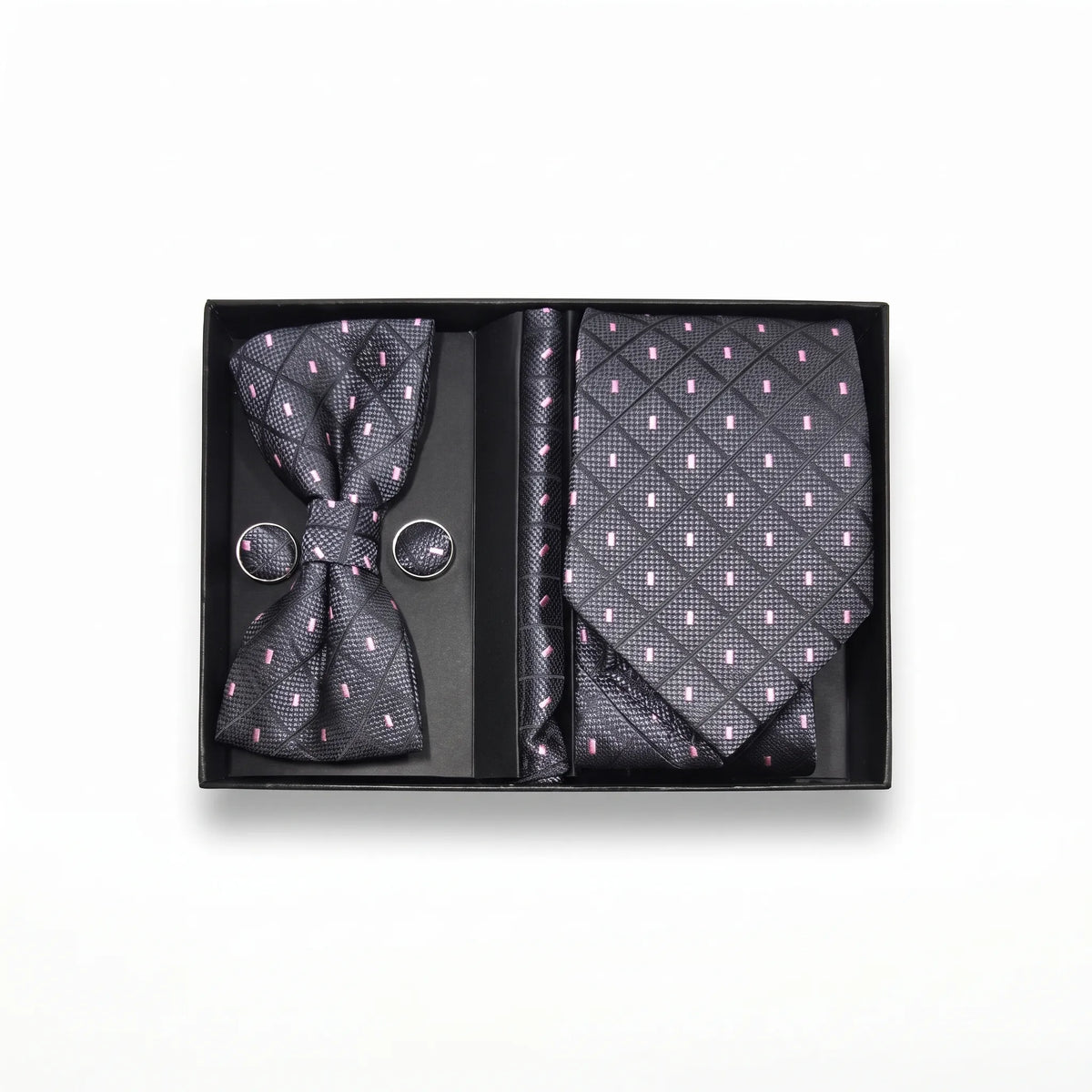A men's formal accessory gift set in a black presentation box, featuring a dark patterned bow tie, matching necktie, and round cufflinks with a subtle pink and gray geometric design.