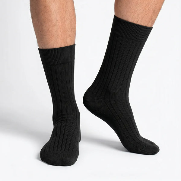 Close-up of a man's feet wearing classic black ribbed crew socks.