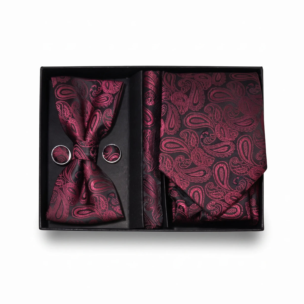 A men's formal accessory gift set in a black presentation box, featuring a paisley patterned bow tie, matching pocket square, and two matching cufflinks on a white background.