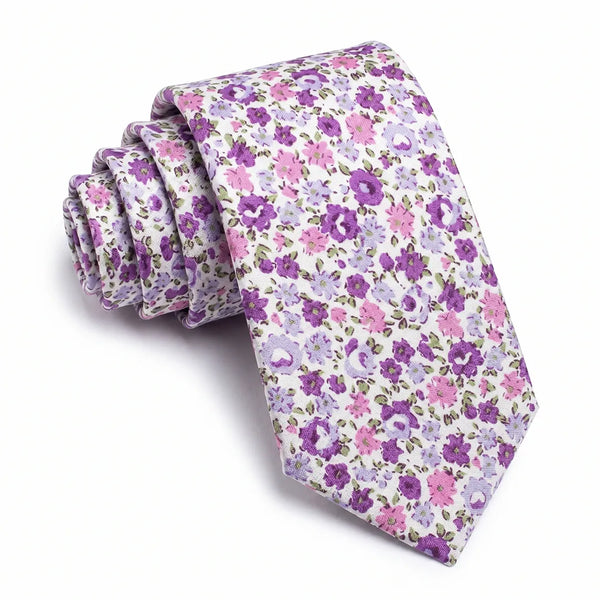 Close-up of a white cotton tie featuring a dense purple, lavender, and pink ditsy floral pattern.