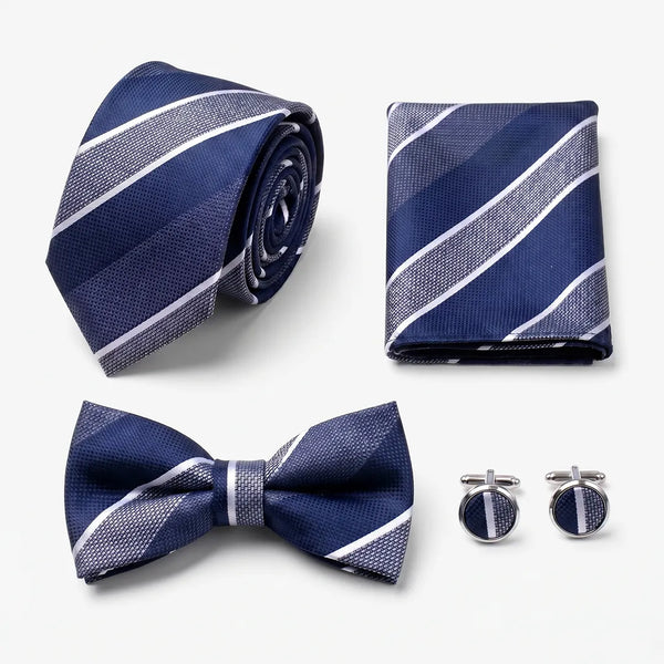 Flat lay of a Sailor Australia navy striped 4-piece tie set including a tie, pocket square, bow tie, and cufflinks.
