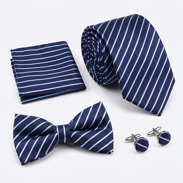 Flat lay of a Sailor Australia navy and white stripe 4-piece tie set including a tie, pocket square, bow tie, and cufflinks.