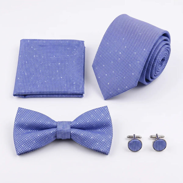 Flat lay of a Sailor Australia periwinkle blue micro-dot 4-piece tie set including a tie, pocket square, bow tie, and cufflinks.