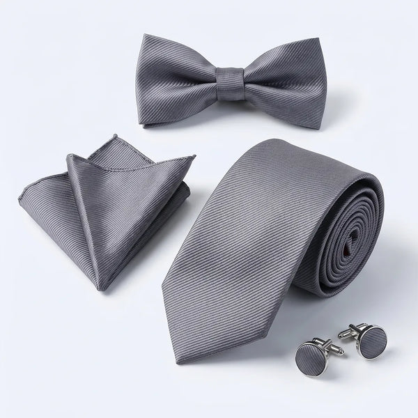 Flat lay of a Sailor Australia grey twill 4-piece tie set including a tie, pocket square, bow tie, and cufflinks.