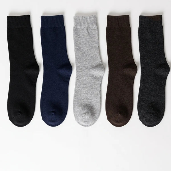 Flat lay of a 5-pack of men's solid ribbed socks in black, navy blue, light grey, brown, and dark grey.