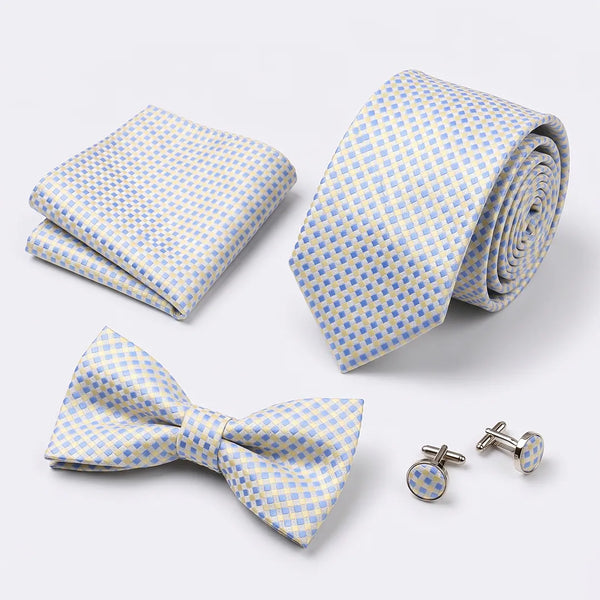 Flat lay of a Sailor Australia pastel blue and cream gingham 4-piece tie set including a tie, pocket square, bow tie, and cufflinks.