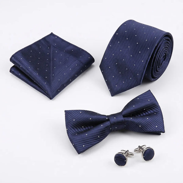 Flat lay of a Sailor Australia navy twill dot 4-piece tie set including a tie, pocket square, bow tie, and cufflinks.