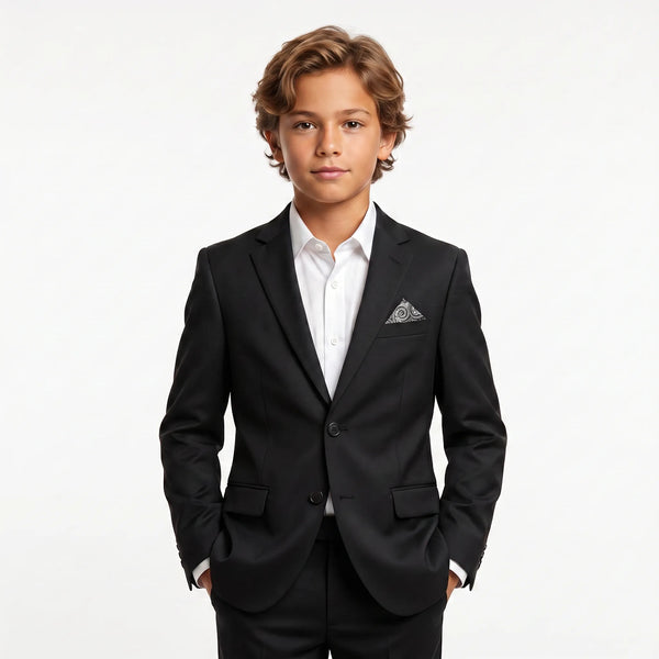 Young boy wearing a black 2-piece suit with a white shirt and patterned pocket square.