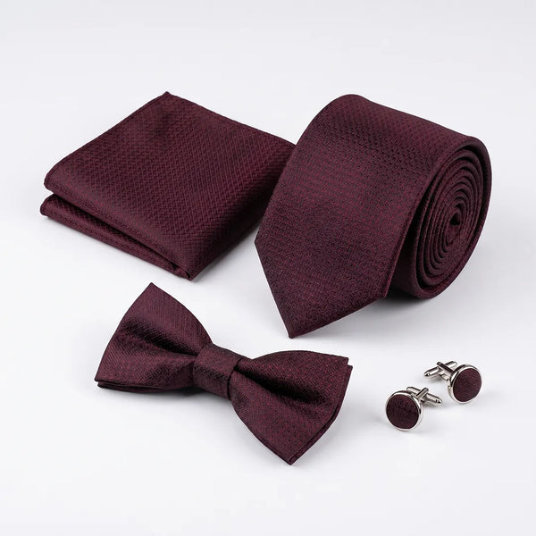 Elegant minimalist flat lay of a Sailor Australia deep burgundy textured tie set styled with a white dress shirt, belt, and cologne.