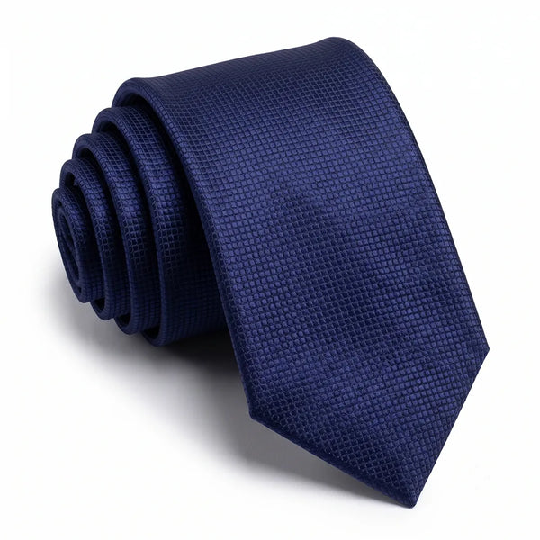 Close-up of a solid navy blue micro-grid textured necktie featuring a subtle structured surface on a smooth polyester fabric.