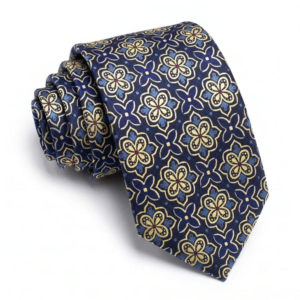 Close-up of a navy gold medallion tie featuring cream outlines, light blue petals, and red center dots on a smooth polyester fabric.