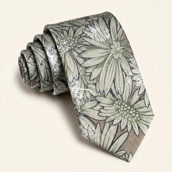 Close-up of a sage green and beige botanical floral silk tie with white sketch outlines.