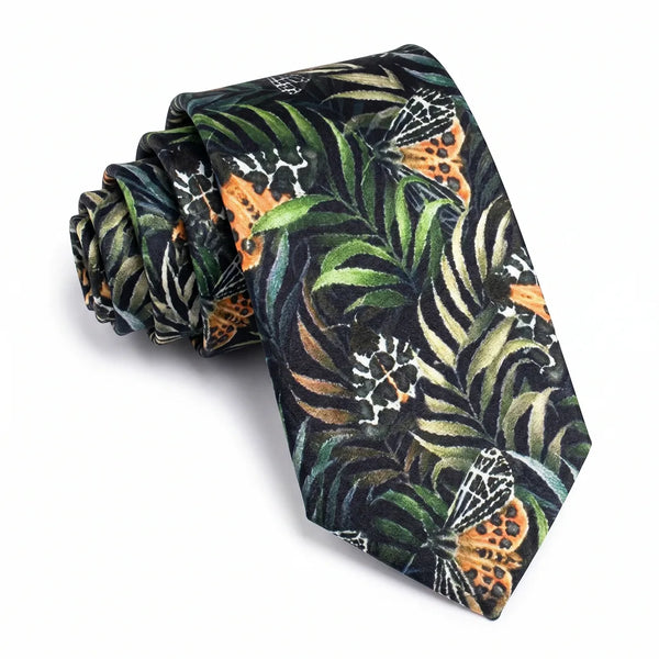 Close-up of a black tropical floral silk tie featuring lush green palm leaves and bright orange botanical accents.