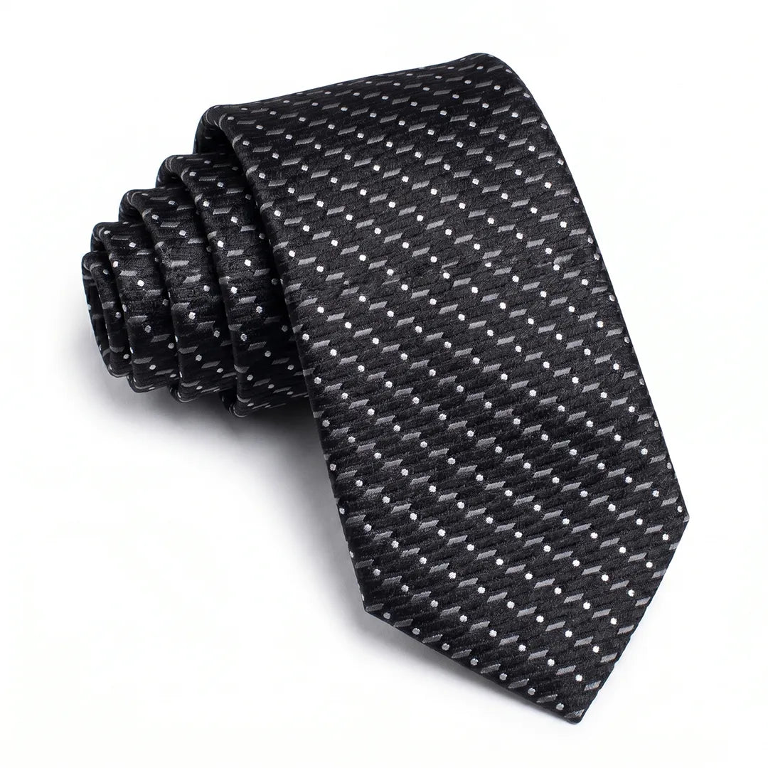 Close-up of a black skinny tie featuring a textured micro-dot and dash pattern on a smooth polyester fabric.