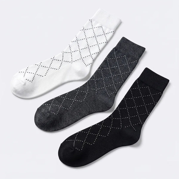 Flat lay of a 3-pack of men's dotted dash socks in white, dark grey, and navy blue.