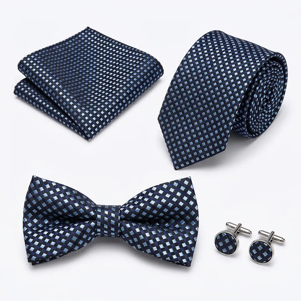 Flat lay of a Sailor Australia navy geo-grid 4-piece tie set including a tie, pocket square, bow tie, and cufflinks.
