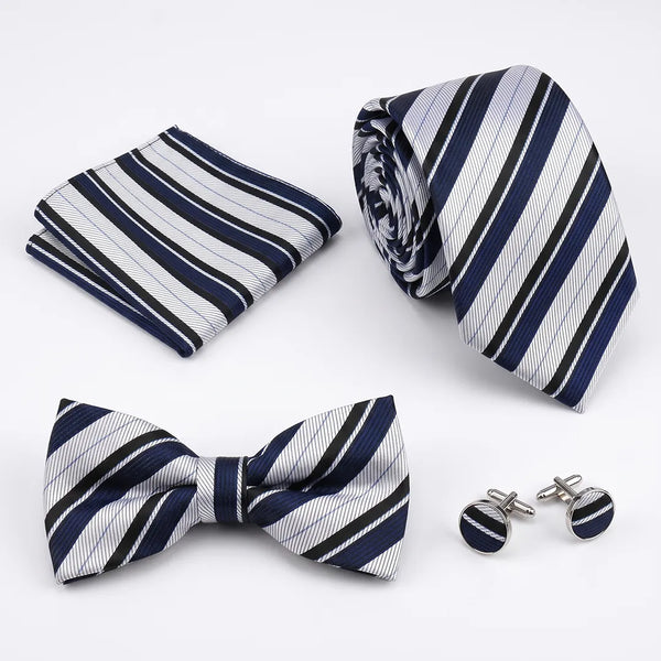 Flat lay of a Sailor Australia white, navy, and black stripe 4-piece tie set including a tie, pocket square, bow tie, and cufflinks.