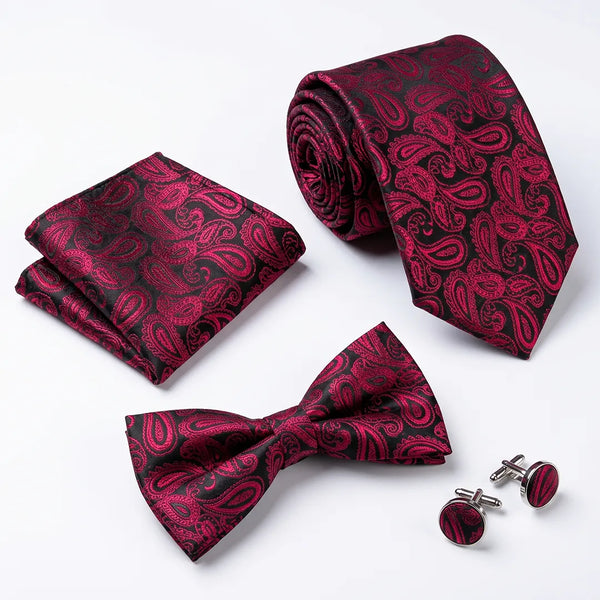 Flat lay of a Sailor Australia black and magenta paisley 4-piece tie set including a tie, pocket square, bow tie, and cufflinks.