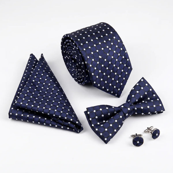 Flat lay of a Sailor Australia navy geometric square 4-piece tie set including a tie, pocket square, bow tie, and cufflinks.