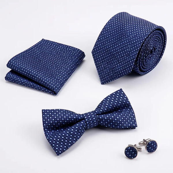 Flat lay of a Sailor Australia navy micro-dot 4-piece tie set including a tie, pocket square, bow tie, and cufflinks.