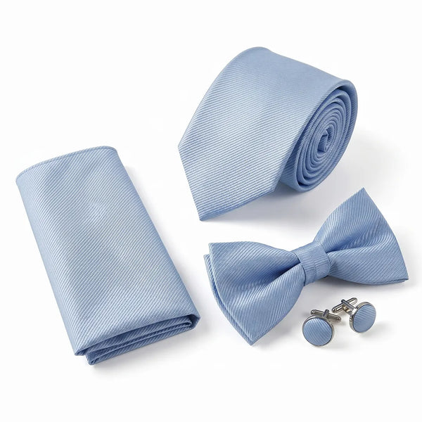 Flat lay of a Sailor Australia powder blue twill 4-piece tie set including a tie, pocket square, bow tie, and cufflinks.