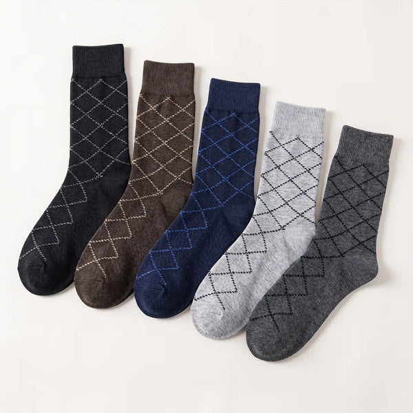 Flat lay of a 5-pack of men's diamond argyle socks in black, brown, navy blue, light grey, and dark grey.