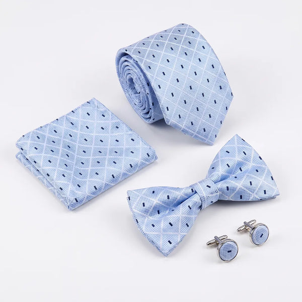 Flat lay of a Sailor Australia light blue diamond dotted 4-piece tie set including a tie, pocket square, bow tie, and cufflinks.