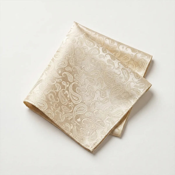 Close-up of a folded champagne beige paisley jacquard polyester pocket square.