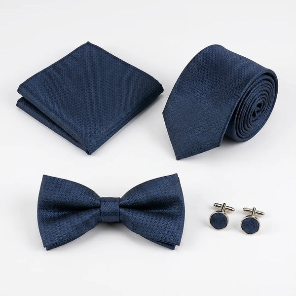 Flat lay of a Sailor Australia navy textured 4-piece tie set including a tie, pocket square, bow tie, and cufflinks.