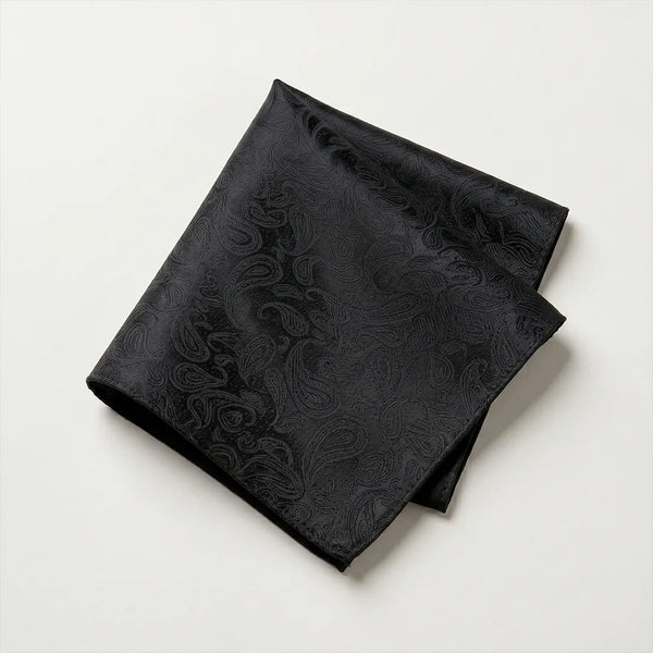 Close-up of a folded black tone-on-tone paisley jacquard polyester pocket square.