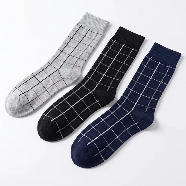 Flat lay of a 3-pack of men's dotted dash socks in white, dark grey, and navy blue.