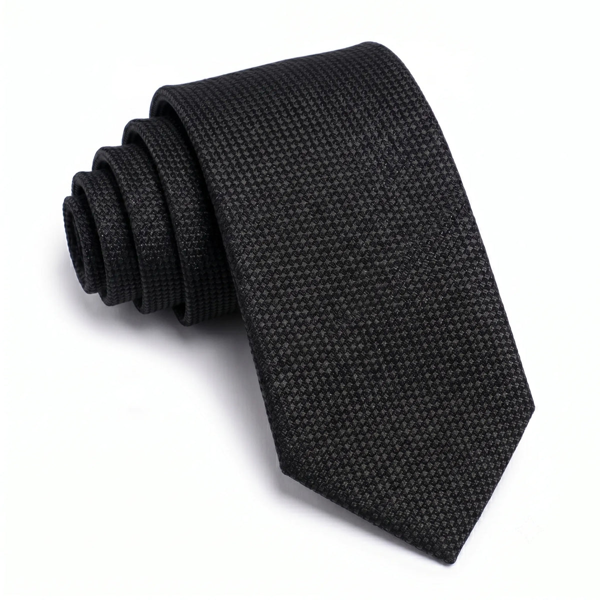 Close-up of a black skinny tie featuring a textured woven micro-grid pattern on a premium cotton fabric.