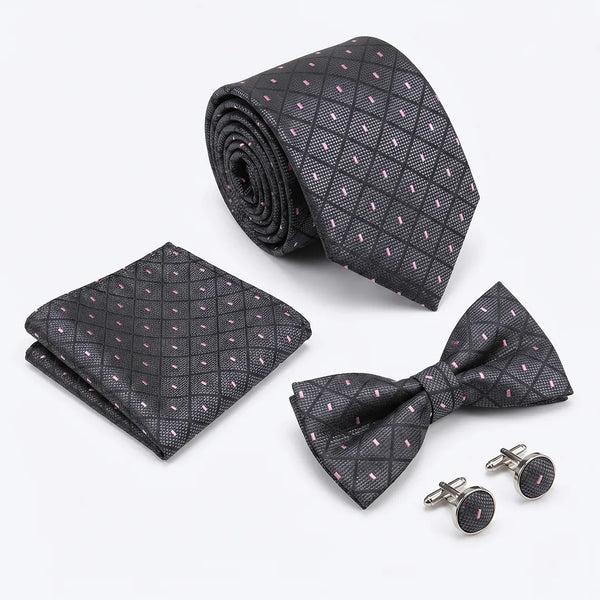 Flat lay of a Sailor Australia black and pink diamond dotted 4-piece tie set including a tie, pocket square, bow tie, and cufflinks.