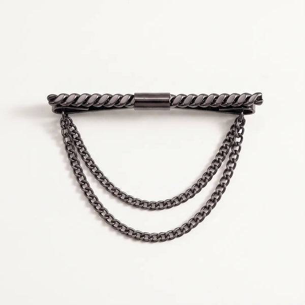 Close-up of a polished dark gunmetal horizontal collar pin with a twisted rope texture and two tiered, draped curb chains.