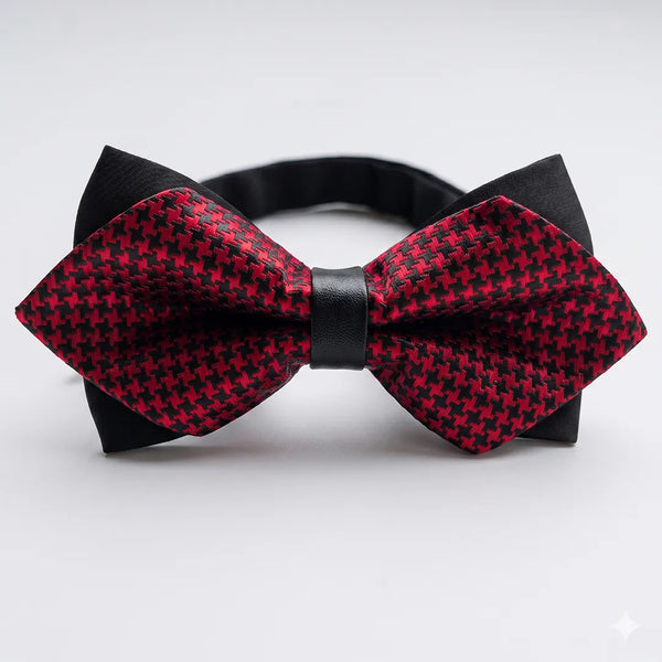 Close-up of a red and black houndstooth diamond bow tie featuring sharp pointed edges and a contrasting black center knot on a smooth polyester fabric.