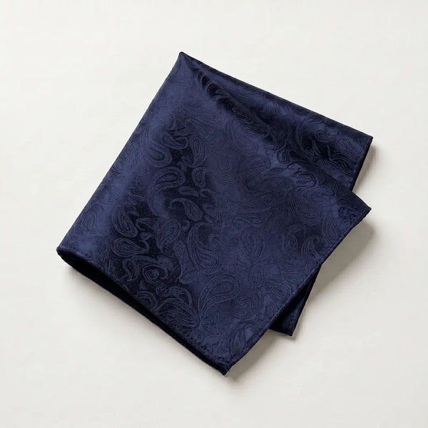 Close-up of a folded navy blue tone-on-tone paisley jacquard polyester pocket square.