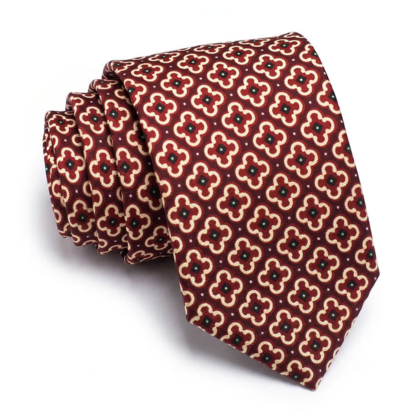 Close-up of a burgundy geometric quatrefoil tie featuring cream outlines and dark green center dots on a smooth polyester fabric.