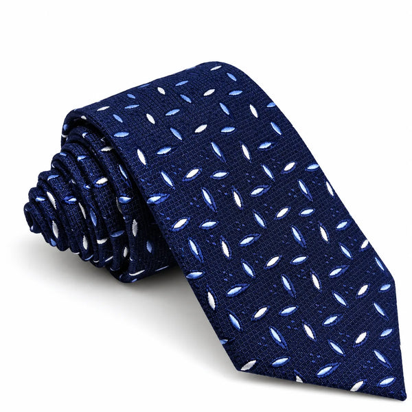 A navy blue necktie with a repeating pattern of small white and light blue teardrop-shaped dots, shown rolled and unrolled on a white background.
