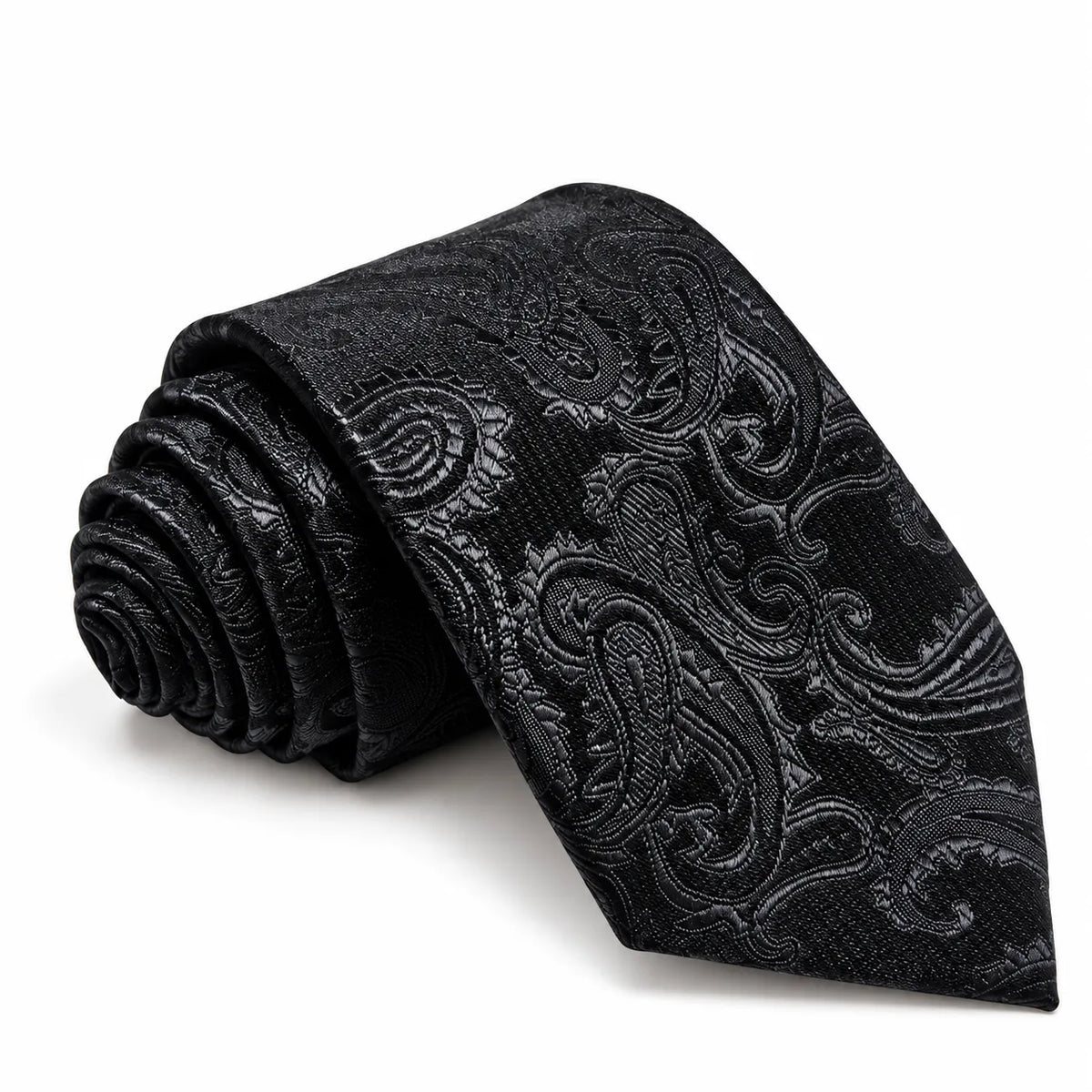 A rolled black necktie with a textured, slightly metallic black-and-charcoal paisley pattern, displayed on a clean white background.