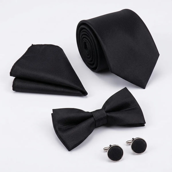 Flat lay of a Sailor Australia black textured 4-piece tie set including a tie, pocket square, bow tie, and cufflinks.