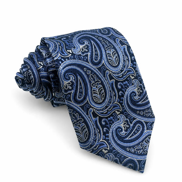 A rolled necktie with an intricate paisley pattern in shades of navy blue, medium blue, and white, set against a clean white background.