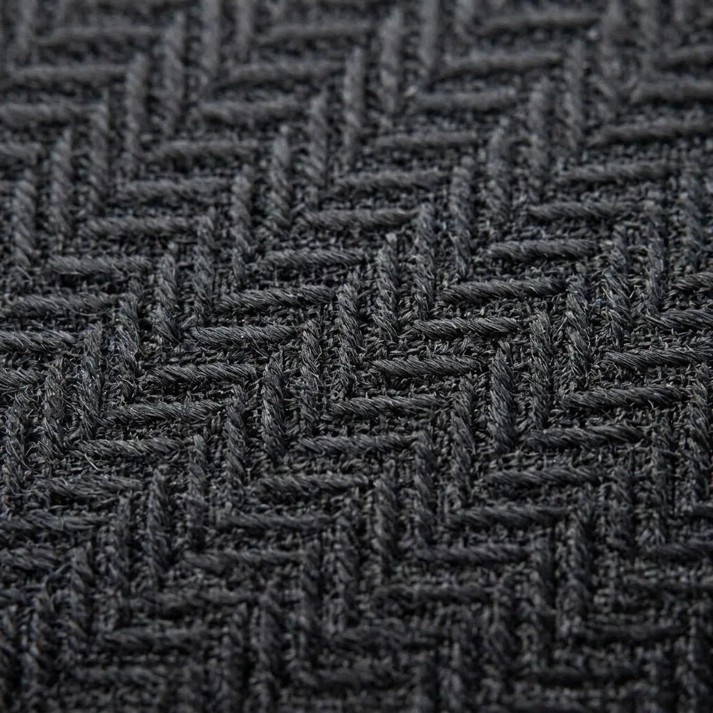 Close-up of a dark charcoal gray woven fabric with a textured herringbone pattern.