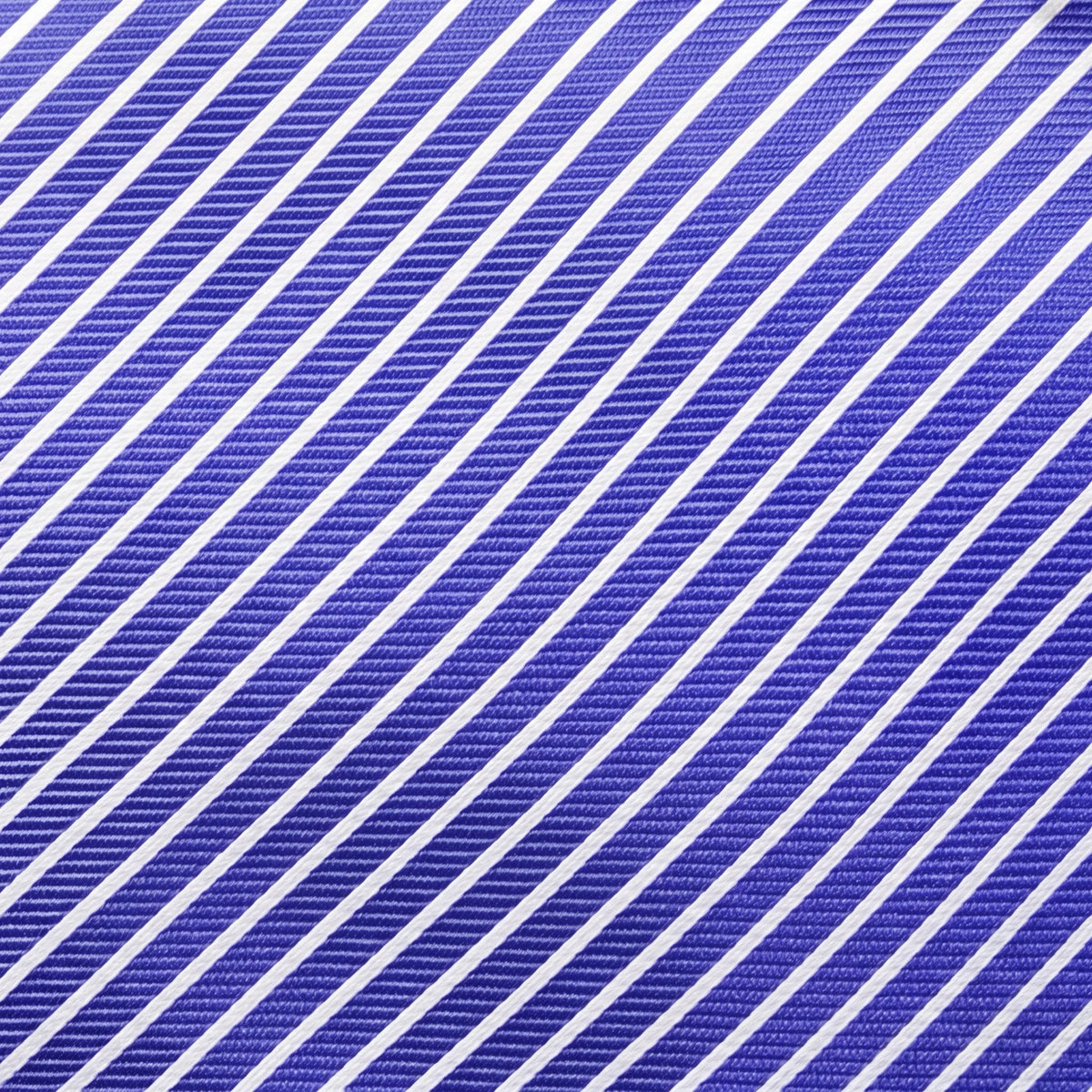 A close-up of a fabric texture featuring a diagonal striped pattern in royal blue and white.