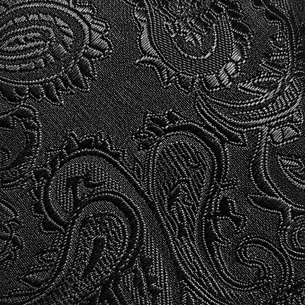 Close-up of a black jacquard fabric with an intricate paisley and floral woven pattern.