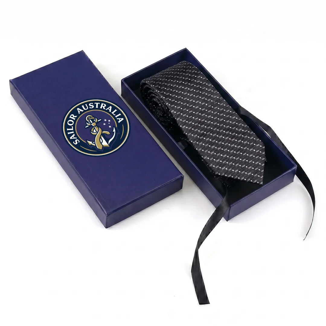 Sailor Australia black and white micro-dot skinny tie displayed inside its premium branded navy blue gift box.