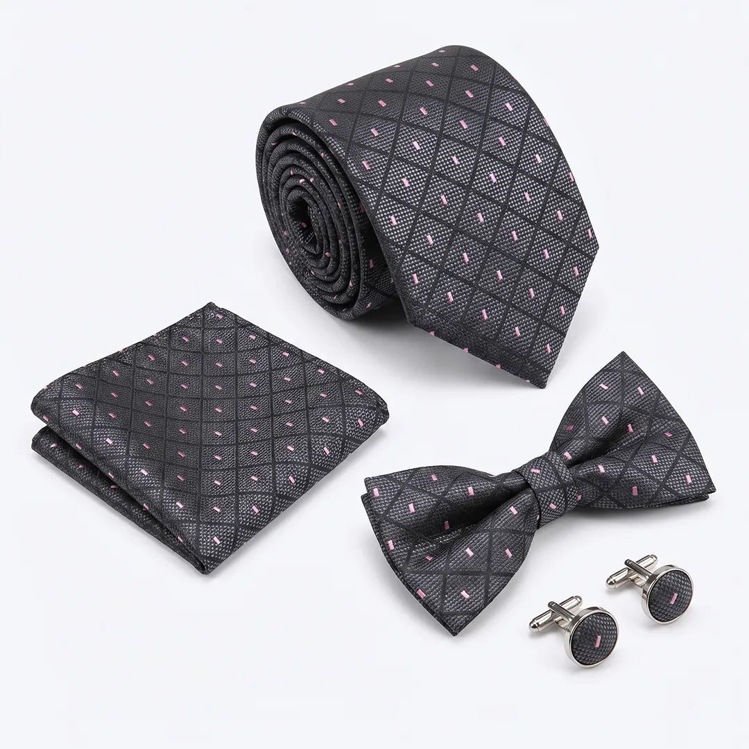 A men's formal accessory set including a necktie, matching pocket square, bow tie, and cufflinks, all featuring a dark charcoal gray and black diamond lattice pattern with small pink and white accents.